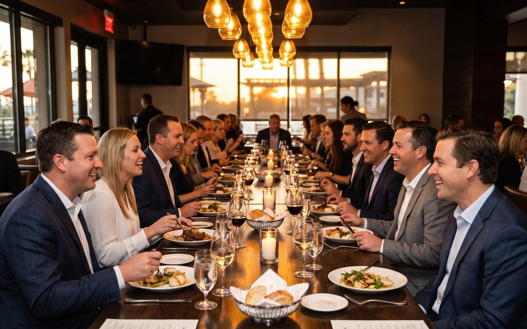 Corporate group dinner in progress at a long private table in a San Diego restaurant
