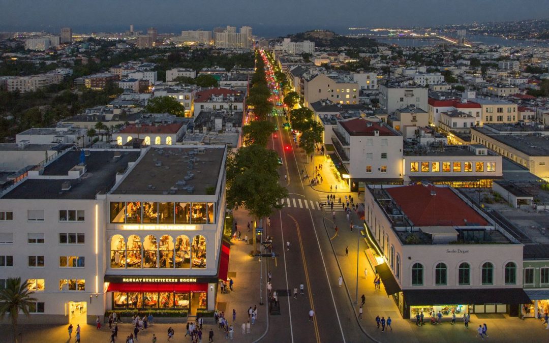 Aerial view of a San Diego dining neighborhood at dusk with restaurants lit along the main street